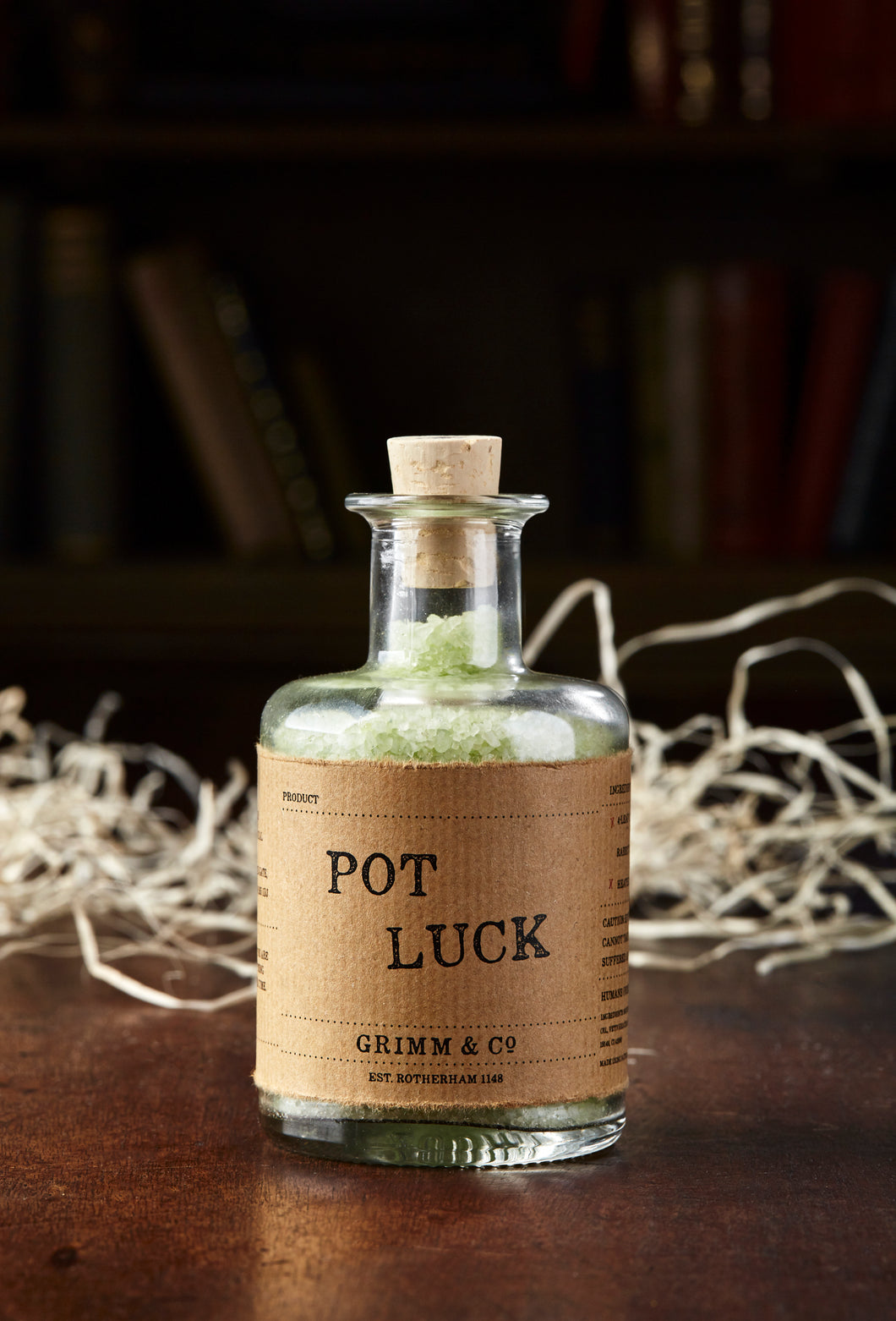Image of Pot Luck, otherwise known as scented pale green bath salts in a glass bottle with cork.