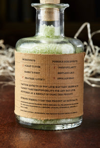 Image of the back label of Pot Luck, otherwise known as scented pale green bath salts in a glass bottle with cork.