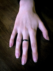 Image shows a hand wearing the Magical Compass ring.