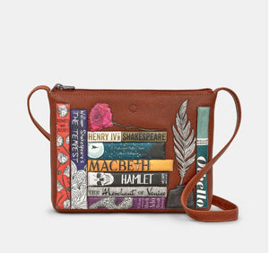 Image showing the brown Yoshi leather cross body bag inspired by Shakespeare with appliqued book titles, a red rose and a feather quill and ink pot. Bag has a zip top and an adjustable strap.
