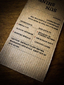 Close up of a Sun Shine kraft paper label showing faux ingredients and side effects