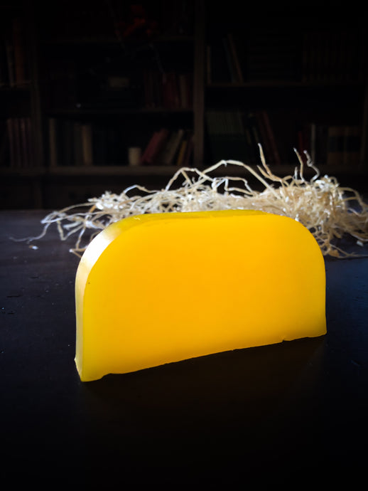 Image of a Sun Shine bar, a bright yellow solid shampoo slice shown without label