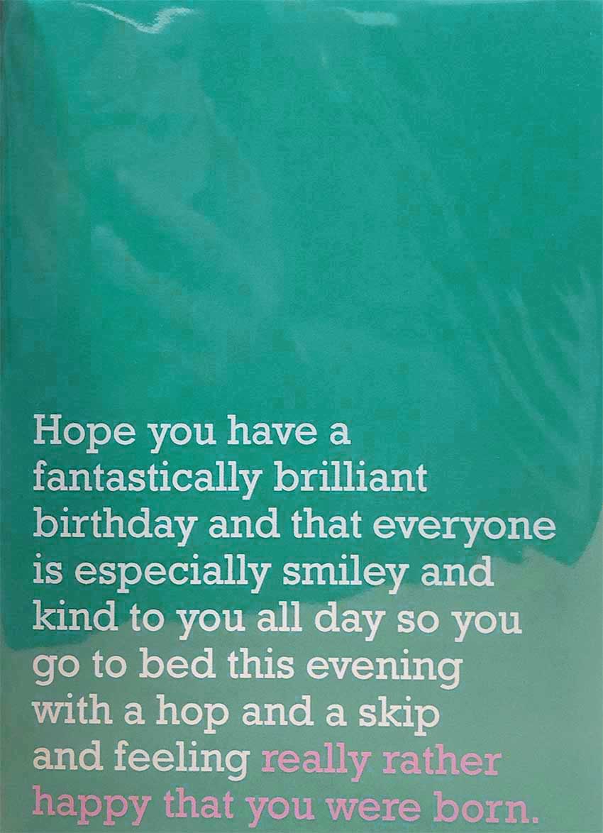 Image of front of greeting card featuring message in white text on teal background saying 'Hope you have a fantastically brilliant birthday and that everyone is especially smiley and kind to you all day so you go to bed this evening with a hop and a skip and feeling really rather happy that you were born'. The 'really rather happy that you were born' is printed in pink.