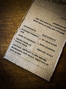 Close up of Tranquility kraft paper label showing faux ingredients and side effects
