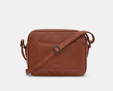 Load image into Gallery viewer, Image shows the brown vegan Yoshi leather camera-style bag from the back view with adjustable shoulder/cross-body strap and slip pocket embossed with YOSHI at the bottom.