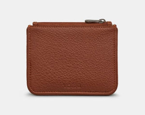 Image shows the back view of the brown vegan Yoshi leather zip top purse embossed with YOSHI at the bottom.