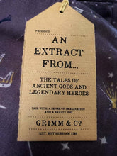 Load image into Gallery viewer, Image of the story extract scarf &#39;Extract from a tale of heroes&#39; with a printed pattern of zodiac constellations such as pegasus and little bear among shooting stars and distant planets in white and yellow on a background of lilac-grey. Kraft paper label is shown with the description &#39;An extract from the tales of ancient gods and legendary heroes&#39;.