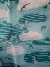 Load image into Gallery viewer, Image of the story extract scarf &#39;Extract from a tale on the moors&#39; with a printed pattern of sky blue striped clouds, white clouds and swallows in grey, blue and white on a baby blue background. Image shows detail of full printed pattern.