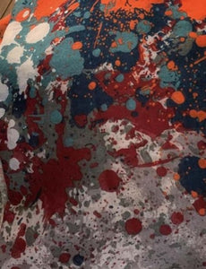 Image of the story extract scarf 'Extract from a tale of windswept abbeys' with an abstract printed pattern of of red, orange white, steel blue and navy blue splatters on a background of light grey. Image shows detail of full printed pattern.