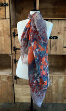 Load image into Gallery viewer, Image of the story extract scarf &#39;Extract from a tale of windswept abbeys&#39; with an abstract printed pattern of of red, orange white, steel blue and navy blue splatters on a background of light grey. Scarf displayed tied around a mannequin.