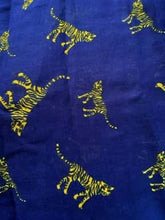 Load image into Gallery viewer, Image of the story extract scarf &#39;Extract from a tale in the jungle (tiger)&#39; with a printed pattern of yellow tigers with dark blue stripes set on a background of royal blue. Image shows detail of full printed pattern.
