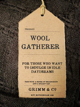 Load image into Gallery viewer, Close up image of the Kraft paper label for the Wool Gatherer scarf. Label states &#39;for those who want to indulge in idle daydreams&#39;.