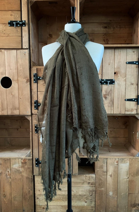 Image of a loosely woven, moss green unisex scarf with tassels along the bottom edges. Scarf is shown wrapped around a mannequin.