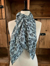 Load image into Gallery viewer, Image of the story extract scarf &#39;Extract from a tale of travel&#39; with a printed pattern of hot air balloons in grey and black. Scarf displayed tied around a mannequin.