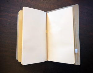 Image of an open journal showing the refillable blank kraft insert.