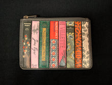 Load image into Gallery viewer, Image shows the Yoshi Coin Keeper purse featuring book titles by the Bronte Sisters. Purse is a dark grey leather and a zip across the top.