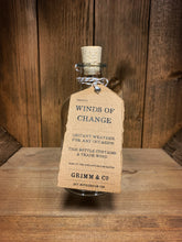 Load image into Gallery viewer, Image of the Winds of Change bottle from the Airs and Graces range: An empty glass potion bottle with cork. The bottle has a kraft tag around the neck, reading: Winds of Change.  Instant weather for any occasion. This bottle contains a trade wind