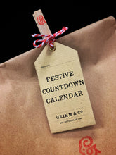 Load image into Gallery viewer, Image shows a close up of the Festive Countdown Calendar label. 