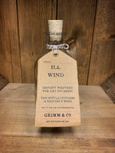 Load image into Gallery viewer, Image of the Ill Wind bottle from the Airs and Graces range: an empty glass potion bottle with cork. The bottle has a kraft tag around the neck, reading: Ill Wind. Instant weather for any occasion. This bottle contains a westerly wind. 