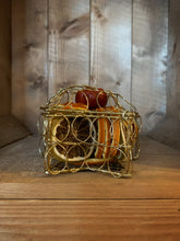 Load image into Gallery viewer, Side on view image of Scent of the Season Star Centrepiece sat flat on a surface, a gold wire box in the shape of a star filled with pot pourri including dried orange and green orange slices and a dried mini pumpkin