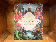 Load image into Gallery viewer, Image of Mythopedia showing the front cover with brightly coloured illustrations of mythical creatures and locations with gold foil detail..