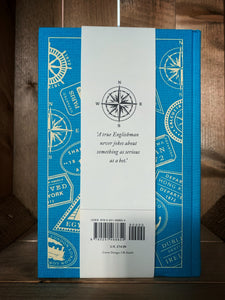 Image of the clothbound classic book Around the World in 80 Days with a kingfisher blue background. The back cover features a cream print design with images of vintage travel stickers from the various locations that Phileas Fogg travels to in the book. There is also a removable belly-band paper label around the back cover with an illustration of a compass and a quote from the book 'A true Englishman never jokes about something as serious as a bet.'