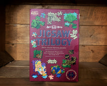 Load image into Gallery viewer, Image of the Jigsaw Library Book Trilogy, featuring three children&#39;s classic book puzzles including The Wonderful Wizard of Oz, Alice&#39;s Adventures in Wonderland and The Jungle Book.
