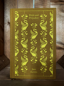 Image of the front cover of the Penguin clothbound classic book Pride & Prejudice featuring a yellow ochre background with a yellow printed repeat pattern of standing swans and leafy stems.