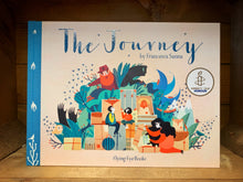 Load image into Gallery viewer, Image shows the front cover of the hardback book The Journey with a beige background and blue text. Cover illustration shows a family surrounded by high piles of suitcases with leaves, mountains, trains, birds behind them with looming guards and shadows overhead.