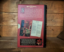 Load image into Gallery viewer, Image of the Jigsaw Library Romeo &amp; Juliet showing the back cover of the book-shaped box and the double-sided puzzle design with the image and an excerpt from the story.