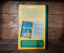Load image into Gallery viewer, Image of the Jigsaw Library The Wonderful Wizard of Oz showing the back cover of the book-shaped box and the double-sided puzzle design with the image and an excerpt from the story.