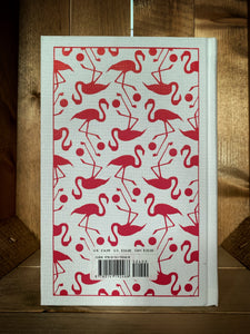 Image of the back cover of the clothbound classic Alice's Adventures in Wonderland, the cover features a repeat pattern print in bright pink with flamingos and croquet balls.