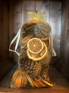 Image of the large gold organza bag of pot pourri including pine cones, dried orange slices, dried whole oranges and cinnamon sticks 