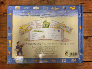 Image of the back cover of The Jolly Postman or Other People's Letters with an illustration showing the book open and letters and cards spilling out of the envelope pages and the postman in the bottom left. Background is pale yellow with a blue border.