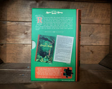 Load image into Gallery viewer, Image of the Jigsaw Library The Jungle Book showing the back cover of the book-shaped box and the double-sided puzzle design with the image and an excerpt from the story.