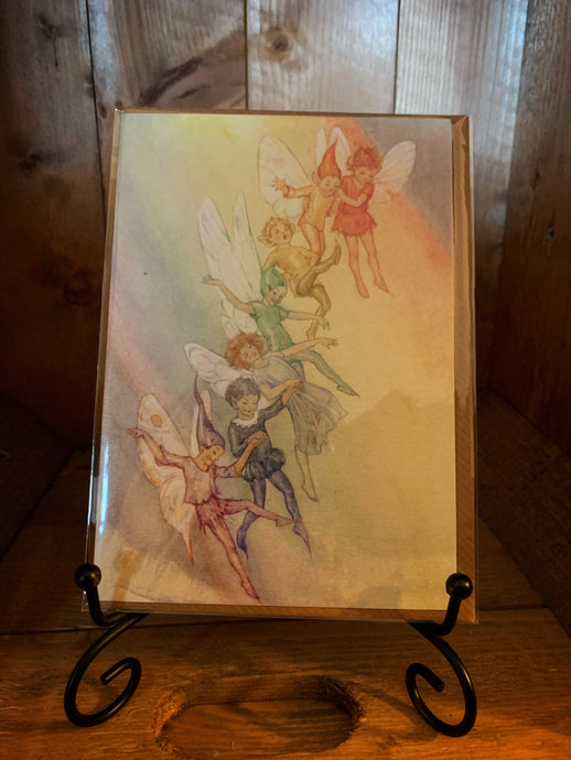 Image of greetings card Fairy Land with Rainbow, a full-colour watercolour style illustration of seven fairies each in a colour of the rainbow