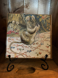 Image of greetings card Beatrix Potter Tailor Mouse with a full colour illustration from the story of Tailor of Gloucester with a mouse threading a needle on embroidered fabric