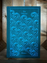 Load image into Gallery viewer, Image of the front cover of the Penguin clothbound classic The Odyssey featuring a teal background and a repeat pattern of printed light blue waves.