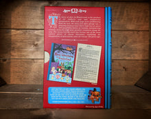 Load image into Gallery viewer, Image of the Jigsaw Library Alice&#39;s Adventures in Wonderland showing the back cover of the book-shaped box and the double-sided puzzle design with the image and an excerpt from the story.