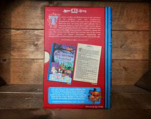 Image of the Jigsaw Library Alice's Adventures in Wonderland showing the back cover of the book-shaped box and the double-sided puzzle design with the image and an excerpt from the story.
