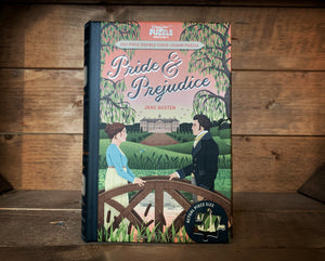 Image showing the book-shaped Jigsaw Library featuring Pride & Prejudice. The front cover design shows Elizabeth Bennett and Mr Darcy stood on a bridge in the grounds of his house Pemberley.