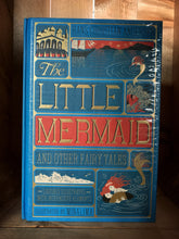 Load image into Gallery viewer, Image of The Little Mermaid and Other Fairy Tales edition by MinaLima. This book features a bright blue clothbound cover wprinted with red, gold and dark blue to showcase images from the Little Mermaid. Images include the undersea castle, the mermaid above the sea watching a ship, a fish amongst coral and the little mermaid with the shipwrecked prince on the waves.