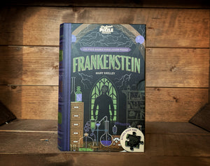 Image showing the book-shaped Jigsaw Library featuring Frankenstein. Design of the front cover shows a dark science lab with Frankenstein stood in front of a gothic window.