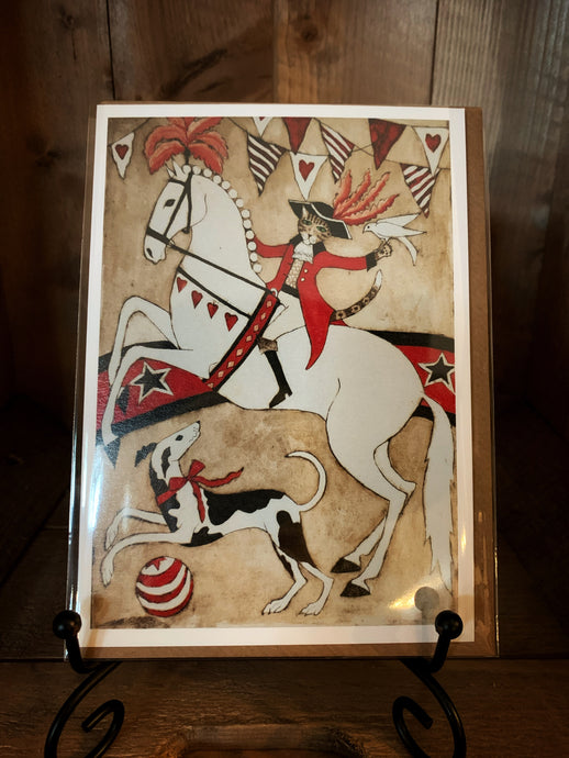 Image of the greetings card showing circus with a cat ringmaster on w white horse with a black and white dog at its feet