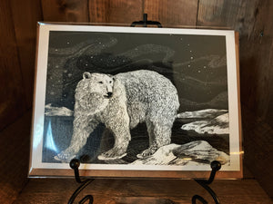 Image of the black and white greetings card Polar Guardian showing a polar bear against the night sky in an iceberg landscape and the Northern Lights in the background