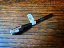 Load image into Gallery viewer, Image shows a full, downward view of the Invisible Ink Pen, with the lid on. The pen has black plastic casing, with a built-in UV light in white casing, and a white on/off switch.