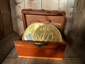 Image shows a few Dragon's Hoard chocolate coins placed upright inside a small treasure chest. 
