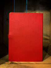 Load image into Gallery viewer, Image shows the back of a Red Note Keeper notebook. The back cover is red PVC, and a red elastics red pen holder can be seen attached on the left hand side.