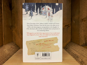 Image shows the back cover of the book Letters from Father Christmas. The wintry illustration continues from the front, with a snowy house at the top. The blurb is written in navy and red text, and there is a photo of one of the Tolkein letter envelopes underneath.