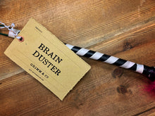 Load image into Gallery viewer, Image showing a close-up of the kraft label saying Brain Duster attached to the black and white striped handle.